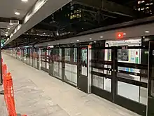 Picture of Chatswood station. It consists of a metro train at a platform with platform screen doors.