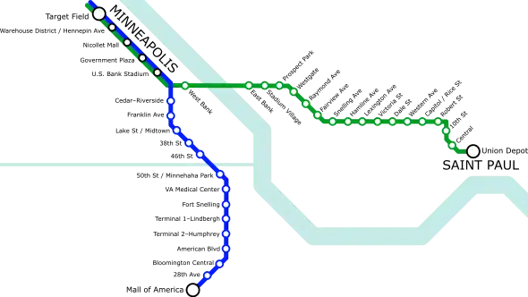 A simple transit diagram with a green line stretching roughly left to right (west to east) and a blue line stretching roughly top to bottom (north to south). A light blue river runs from the top right to the bottom right, roughly following the shape of a ladle. Another thinner waterway runs straight from center-left to connect with the river near the center of the image.