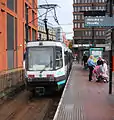 A Manchester Metrolink tram at Piccadily Gardens station in central Manchester