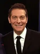 Headshot of a man wearing a formal suit.