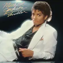 The cover has Jackson reclining in a white suit