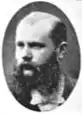 Black and white photo of a bearded man