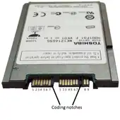 A 1.8-inch micro SATA hard drive with numbered data and power pins on the connector