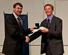 Mike Irwin receiving the Herschel Medal from Roger Davies in 2012