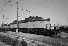 An electric locomotive with its pantographs down