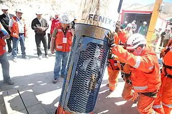 Color image of the fifth rescuer, Patricio Sepúlveda, is in the rescue capsule and is being lowered into the San José Mine, during "Operación San Lorenzo".