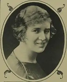 A white woman with short fair hair, in an oval frame