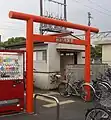 Another view of the station entrance. The concrete structure behind the torii is not the station building but a toilet.