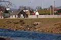 Confluence of the river Hornád and the local stream Moňok, older housing at the riverfront