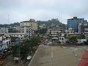 Broad street in Monrovia. The Ducor Hotel is visible on the hilltop in the background.