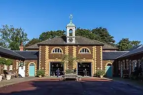 building in dark brown stone with clock tower