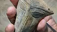 "A holding the Chalcolithic mask"