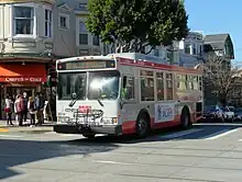 A bus crossing an intersection in a commercial district