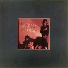 A saturated red image of four people surrounded by a grey border. Text inside the image reads "My Bloody Valentine Ecstasy".