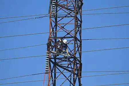 A line worker on a tower