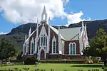 Very fine Cape Gothic dressed stone church with white plaster detailing.
Decoration is unusually 'spiky'.
This church in the Neo-Gothic style, was designed by Carl Otto Hager.
The foundation stone was laid on 12 August 1880.
The building was completed early in 1882 and was officially inaugurated on 28 April.
Type of site: Church
Current use: Church : Dutch Reformed.