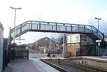 Platform, signal box and pedestrian bridge over tracks