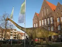 Model of a long-necked dinosaur outside a museum