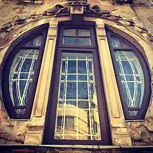 Mix of Art Nouveau and Egyptian Revival – Round corner window of the Romulus Porescu House (Strada Doctor Paleologu no. 12) in Bucharest, decorated with lotus flowers, a motif used frequently in Ancient Egyptian art, designed by Dimitrie Maimarolu (1905)