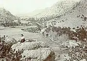 Neil Erickson relaxing on top of a rock formation overlooking his homestead in Bonita Canyon.