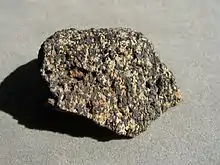 A speckled rock with black and white grains