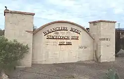 The Wranglers Roost Stagecoach Stop front gate.