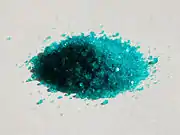 A small heap of cyan crystal particles