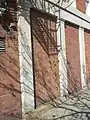 Street Building along State St. Monolithic granite piers with Doric capitals marking the original street storefronts.