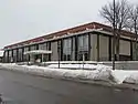 North Regional, a tall, one-story glass and concrete library on a snowy, cloudy day