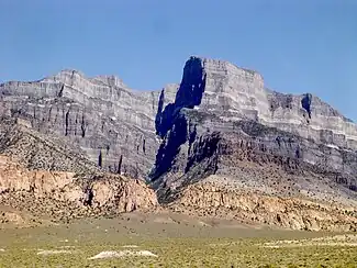 Pink monzonite laccolith intrudes within the grey Cambrian and Ordovician strata near Notch Peak, Utah