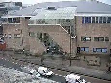 Elevated view of a light coloured building alongside a road