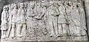 The relief on the Noyon monument aux mort which records the presentation to Noyon on 10 July 1920 of the Légion d'honneur and the Croix de guerre in recognition of the suffering and fortitude of the citizens of Noyon during the German occupation