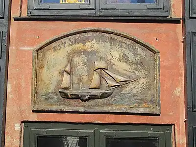 Ship relief below one of the windows.