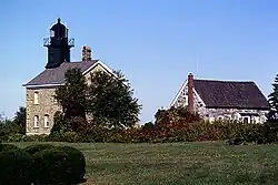 The Old Field Point Light, which, along with the adjacent Keeper's Cottage, serves as the village's Village Hall complex.