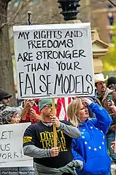  Ohio protestor with sign saying, "My rights and freedoms are stronger than your false model"