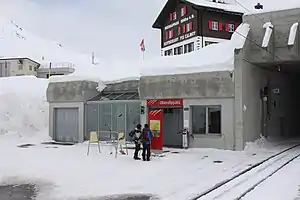 Single-story building set in a hillside next to a tunnel