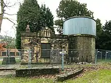 the observatory; a stone building with a round tower, the top of which is clad in metal