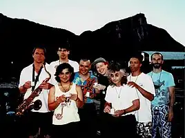 Oingo Boingo circa 1990. From left to right: Sam "Sluggo" Phipps, Steve Bartek, John Avila, Johnny "Vatos", Danny Elfman, Dale Turner, Carl Graves, Leon Schneiderman