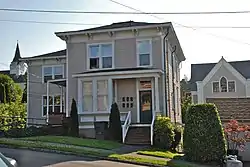 Photograph of the Old Grace Episcopal Church Rectory, a two-story house on a steep cross-slope