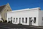 Mid 19th century, single storied, flat roofed building with handsome cornice. Reused as the school to children of Congregation using St. Luke's. School building and adjacent St. Lukes make a contrasting and historical pair. Very important. Type of site: School Previous use: School. Current use: Offices.