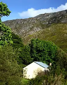 This old toll-house, situated within the Kristalkloof Forest Reserve, is still in a very good state of preservation and stands, as it were, on an island between the old road passing in front of it and the new road passing behind it.
A few old and tall cyp The pass was named in honour of the Commissioner of Riversdale at that time, A.H. Garcia.
He himself went to investigate the feasibility of a road through the mountains and in 1872 the Cape Parliament decided that Garcia Pass would be constructed.
Type of site: Toll The old Toll House was rebuilt in 1910 on the foundations of an earlier toll house and is a remnant of a system that played an important part in the history of transportation in South Africa.