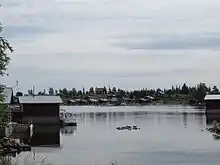 Old fishing huts at Brändöskär today used for recreation. The Brändöskär chapel can be seen on the other side of the bay on the top of the hill.