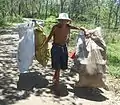 A man carrying everyday items in Hainan, China