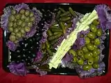 Olives and pickles attractively served on purple cabbage leaves