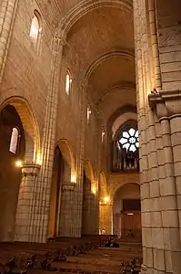 The nave barrel vaulting is supported by thick heavy columns