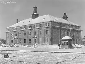 Square, three-story hotel in winter