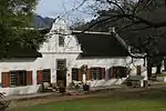 This fine example of a Cape-Dutch gabled house with its concavo-convex ("holbol") gable was probably built early in the Nineteenth Century on the farm which was originally granted in 1714 to Jean Joubert.

Montpellier was granted to Jean Joubert, a Huguen. This fine example of a Cape-Dutch gabled house with its concavo-convex ("holbol") gable was probably built early in the Nineteenth Century on the farm which was originally granted in 1714 to Jean Joubert.