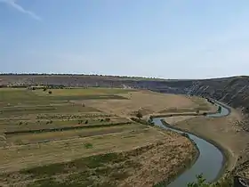 River winding past low farmland