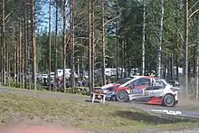 2018 Rally Finland winning crew Ott Tänak and Martin Järveoja driving through the power stage in a Toyota Yaris WRC.