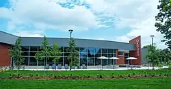 Oxboro, a building with windows inlaid between red brick triangular protrusions, on a sunny summer day